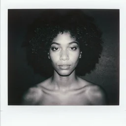 polaroid picture, beautiful light - skinned woman, symmetrical face, curly hair, afro, artistic, black and white, eerie, francesca woodman style