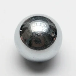 3 5 mm photo of a chrome blob, grainy photography