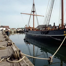 a 1 7 th century ship building yard reflecting on the harbour, ropes and pulleys