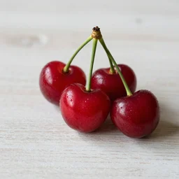Photo realistic three fresh cherries on a table