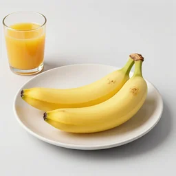 a plate that has no bananas on it. there is a glass without orange juice next to it