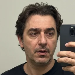 andras arato with a honest reaction, taking a selfie, grainy quality, low quality, low resolution, realistic, hyperrealistic, very realistic, hd quality, intricate details, very detailed, grainy, taken on an iphone, awkward angle, awkward lighting