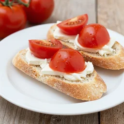photo of bocadilla with tomatos on the plate