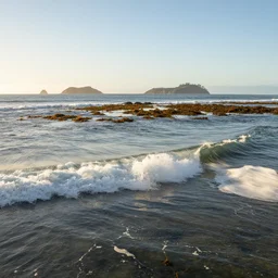 small perfect reef point wave breaking in shallow clear water directly in front, hollister ranch, offshore winds, kelp, islands on horizon, oil dereks on horizon, late afternoon, fall time, central california