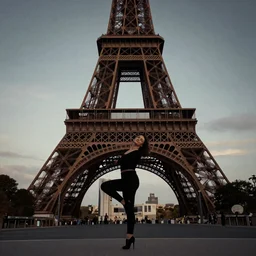 woman dancing in front of the Eiffel tower, photograph, dramatic lighting