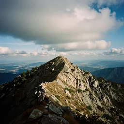 chrome blob on a mountaintop summit, 3 5 mm photography grainy exposed film wide shot pano