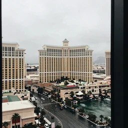 a real photo of las vegas viewed from a very far away wet skyscraper's window on a rainy day, by joel meyerowitz