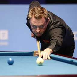 snooker player Doug Mountjoy potting an onion in the middle pocket of a snooker table