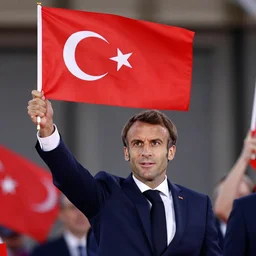 emmanuel macron holding up and waving a turkish!!!! flag!!!!!! enthusiastically, macron's face clearly visible, star and crescent clearly visible, hd, 4 k