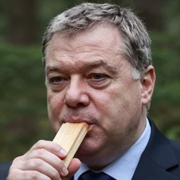 close - up headshot of viktor orban in a forest, highly detailed face, holding a wood piece, very detailed, by peter lindbergh