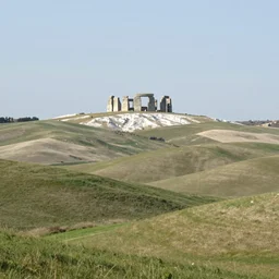 concept art : an italian landscape in bright daylight. soft rolling hills in the foreground. in the distance a small mesa of white marble can be seen. a stone henge is standig atop the mesa