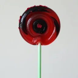 a photo of a swirling red lollipop with a thin green neck wearing a kermit collar, the top is a black and red vortex made of velvet shards in the shape of a head red butter lettuce