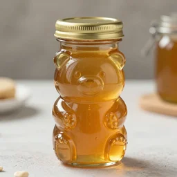 a photograph of a bottle of honey shaped like an owlbear, sharp detail, 5k, food photography, product photography