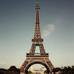 a dress shaped like the eiffel tower, with a little bit of lens flare. fashion photography by annie leibovitz