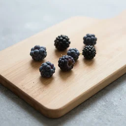 photo of few berries lie on a cutting board on the table